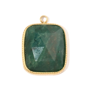 Detailed macro view of a rectangular green stone pendant with a gold star engraving