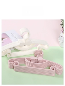 Detail of baby bow plastic hangers showing anti-slip hooks and thick material