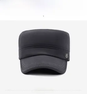Detail of dark grey winter flat cap with metallic shield R-logo and reinforced stitching