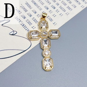 Macro shot of gold cross pendant with cubic zirconia inlay on a stylish background