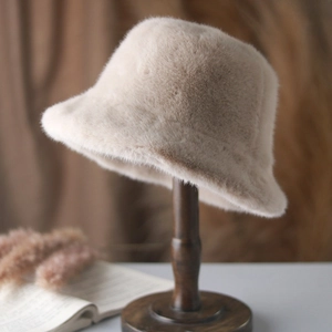Detail view of the soft faux fur texture on a cream-colored winter bucket hat for women