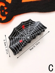 Macro view of black spider web hair claw clip with red spider detail and dimensions