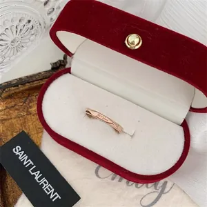 Close-up of rose gold ring with Je t'aime engraving in a red velvet jewelry box