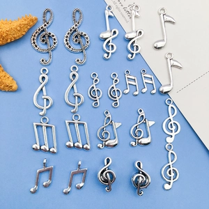 Silver musical note charm pendants in assorted treble clef and stave designs