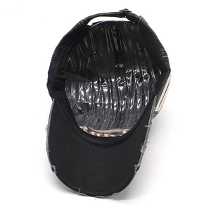 Detail of adjustable metal buckle and frayed vintage edge on cotton baseball cap