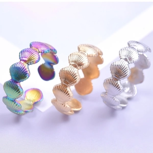 Shell-shaped open titanium steel rings in iridescent, gold, and silver finishes