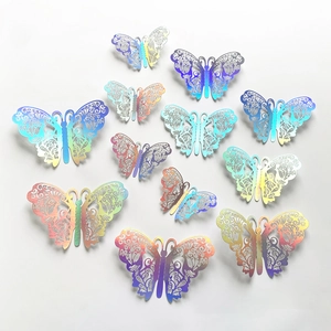 Flat lay of 12 iridescent hollow 3D butterfly wall stickers with metallic rainbow finish