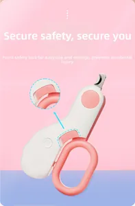 Detail view of pink pet nail clipper showing the side safety lock and LED power indicator