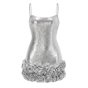 Detail of silver sequin dress featuring 3D floral hem and tiered ruffled textures