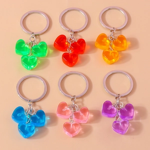 Detailed view of six colorful jelly heart keychains in a flat lay display