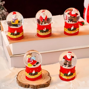 Christmas snow globe gift set with Santa and snowman figures on a festive red base