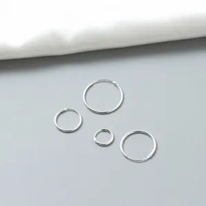 Minimalist S925 sterling silver hoop earrings set in four sizes on silk background