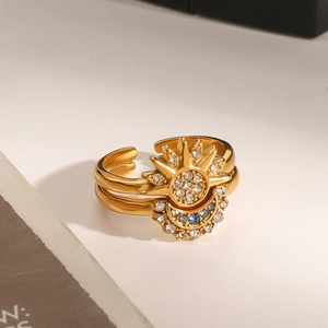 Macro view of gold sun and moon ring with blue stone and sparkling zircons