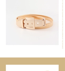 Detailed close-up of a polished gold metallic elastic waist belt with a square buckle