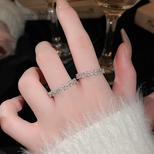Close-up of silver-tone crisscross wave ring with pavé-set sparkling crystals