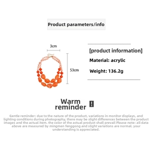 Detailed view of bulky orange and pink acrylic beads for a double-layer statement necklace