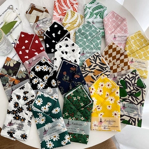 Cotton linen square scarves with floral prints and fashion labels on white background