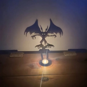 Funny shadow candle stand with monster silhouette projecting on a white wall