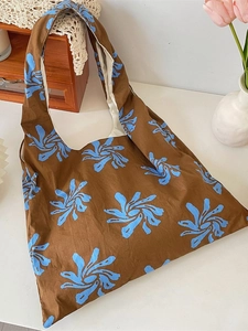 Artistic blue floral canvas tote bag with wide shoulder straps in vintage brown finish