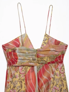 Detailed view of spaghetti straps and pleated bust on floral print midi dress