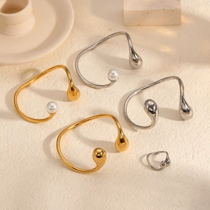 Polished double teardrop open bangles and matching ring set in gold and silver finish