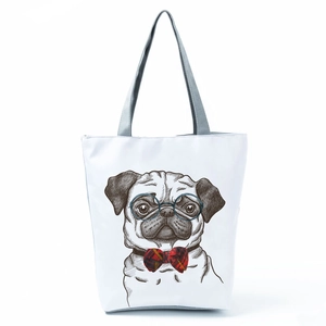 Close-up of white canvas tote bag with pug dog illustration and grey handle