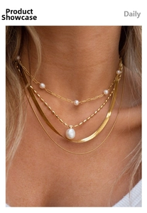 Detailed view of layered 18k gold plated necklaces featuring freshwater pearls and snake chains