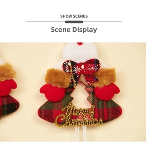 Macro shot of plaid Christmas glove ornament with golden Merry Christmas lettering