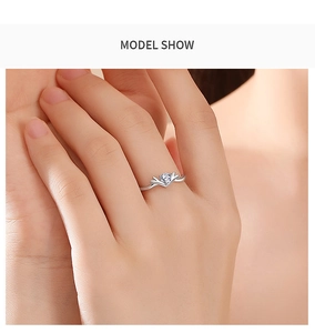 Close-up of V-shaped sterling silver ring with a clear zircon on a model's finger