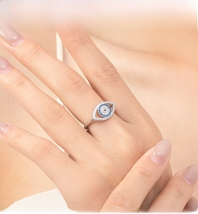 Detail of S925 sterling silver evil eye ring featuring blue stone and pavé white diamonds