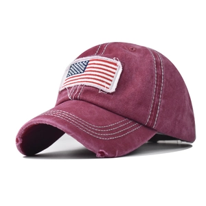 Close-up of US flag embroidery on washed cotton ponytail baseball cap with distressed edge