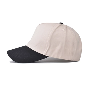 Detail view of cotton baseball cap with beige crown, black brim and stitched eyelets