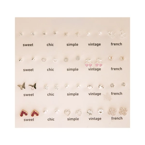 20 pairs of pearl stud earrings set with heart butterfly shapes and crystal details