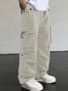 Detail view of side pockets on light beige men's loose fit parachute cargo pants