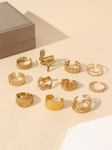 Detail view of 11-piece vintage gold ring set featuring snake and heart motifs