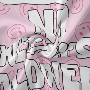 Close-up of pink Bohemian tapestry fabric featuring smileys and No Rain No Flowers text