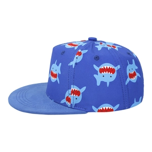 Side view of blue kid's flat brim baseball cap featuring cartoon shark prints