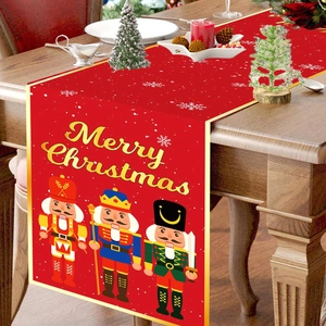 Red Christmas table runner with Nutcracker soldiers and Merry Christmas gold lettering