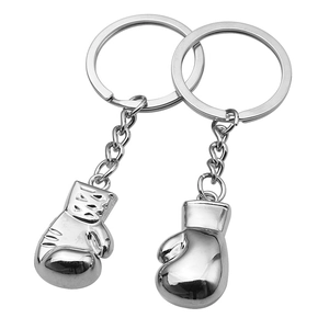 Polished silver metal boxing glove keychain pair with detailed 3D design on white background