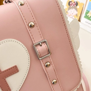 Detail of pink faux leather strap with silver square metal buckle and white wavy trim