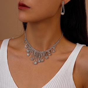 Detail of luxury rhinestone tassel necklace and earrings set on an Asian model