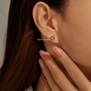 Boucle d'oreille en argent S925 avec pierre rose de 6mm portée sur l'oreille du modèle
