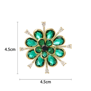 Elegant emerald green crystal flower brooch in gold finish, measures 4.5cm by 4.5cm
