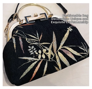 Detailed close-up of bamboo leaves embroidery on a black vintage crossbody handbag