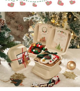 Detail of Christmas gift set with mini knitted gloves and wreath in a pulp box packaging