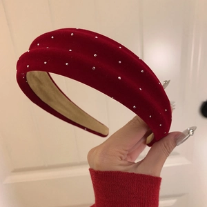 Close-up of a red velvet headband with rhinestones and non-slip inner fabric