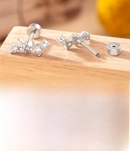 Detail of silver butterfly ear studs with cubic zirconia and screw back specifications