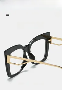Detail of cat eye glasses frame showing black acetate rim and gold metal temples