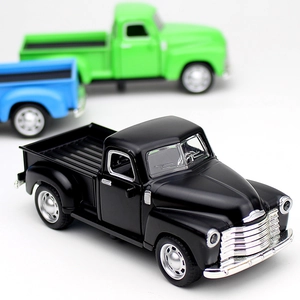 Close-up of vintage alloy pickup truck models in black, blue and green with realistic details