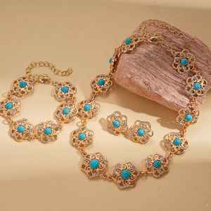 Vintage luxury floral jewelry set with blue stones and crystals on natural wood display